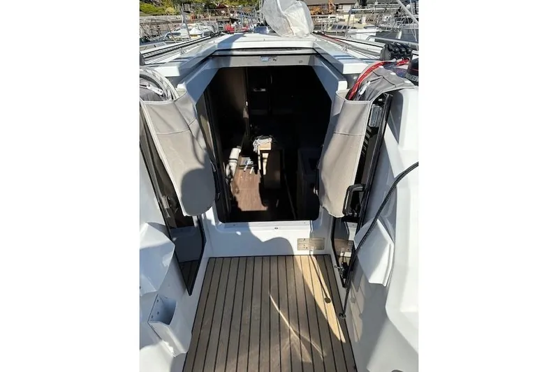 Knotaulis Yacht Photos Pics 2023 Beneteau Oceanis 34.1 yacht interior entrance with wooden deck.