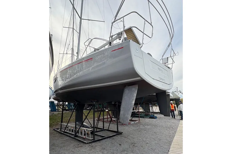 Knotaulis Yacht Photos Pics 2023 Beneteau Oceanis 34.1 sailboat on dry dock, showcasing sleek design and modern features.