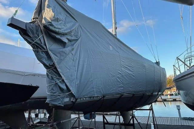 Knotaulis Yacht Photos Pics 2023 Beneteau Oceanis 34.1 sailboat covered with tarp at marina.