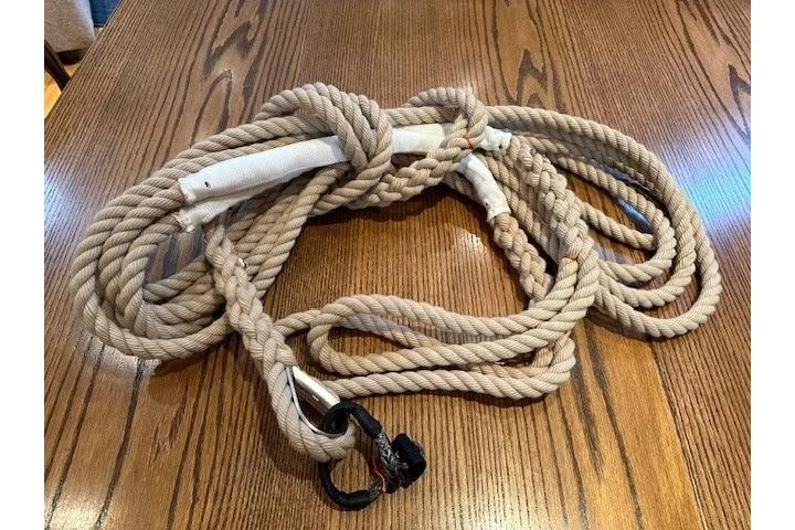 Knotaulis Yacht Photos Pics Coiled rope on wooden table, related to 2023 Beneteau Oceanis 34.1 sailboat.