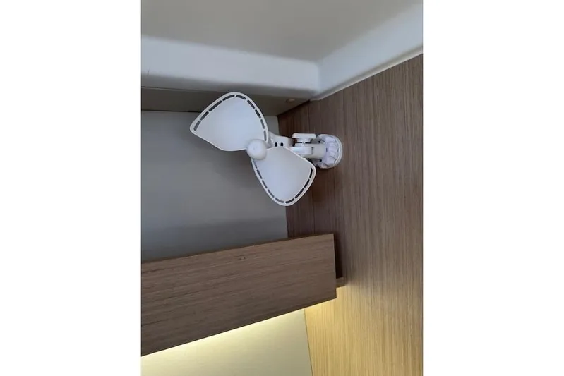 Knotaulis Yacht Photos Pics White fan mounted on wooden interior of 2023 Beneteau Oceanis 34.1 yacht.