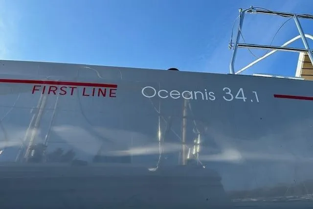 Knotaulis Yacht Photos Pics 2023 Beneteau Oceanis 34.1 sailboat with "First Line" branding on the hull.