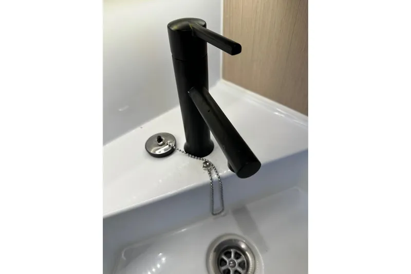 Knotaulis Yacht Photos Pics Modern black faucet on Beneteau Oceanis 34.1 yacht, 2023 model.