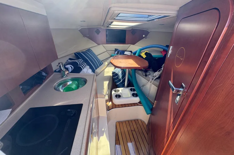  Yacht Photos Pics Interior of 2015 Chris-Craft Corsair 32 boat with kitchenette and seating area.
