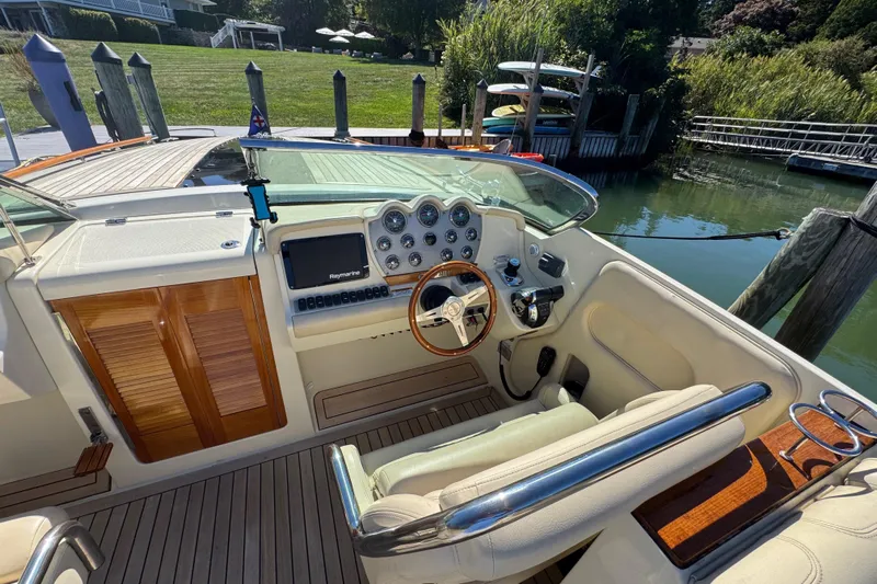  Yacht Photos Pics 2015 Chris-Craft Corsair 32 cockpit with wooden accents and modern controls.
