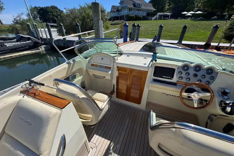  Yacht Photos Pics 2015 Chris-Craft Corsair 32 boat interior with elegant dashboard and seating at dock.