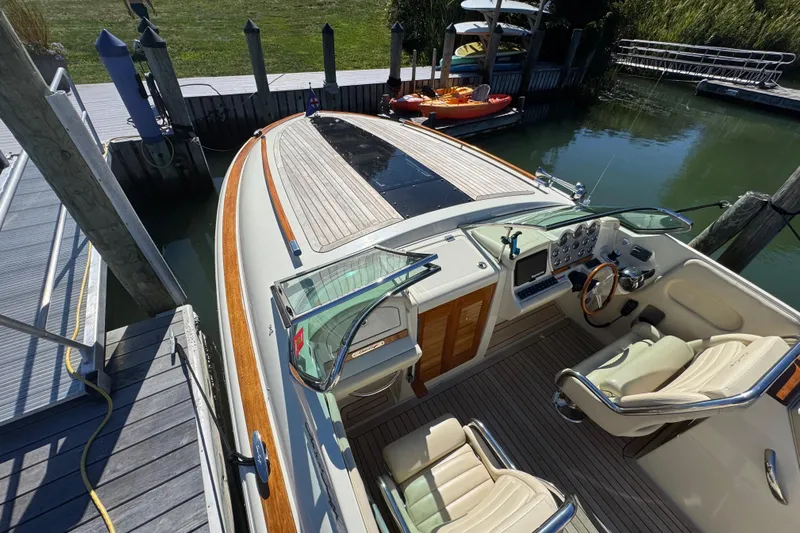  Yacht Photos Pics 2015 Chris-Craft Corsair 32 boat docked, featuring elegant interior and wooden deck.