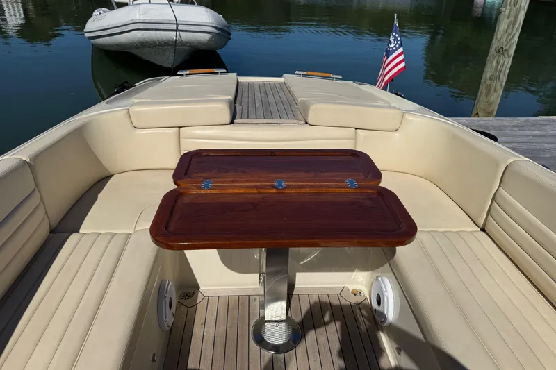  Yacht Photos Pics Luxurious 2015 Chris-Craft Corsair 32 boat interior with elegant seating and wooden table.
