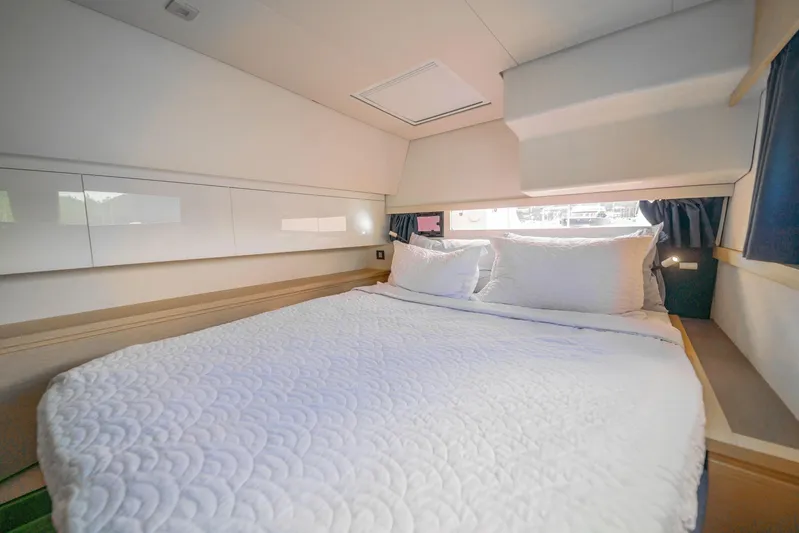 Serenity Yacht Photos Pics Luxurious bedroom interior of 2016 Fountaine Pajot SABA 50 catamaran with cozy bedding.