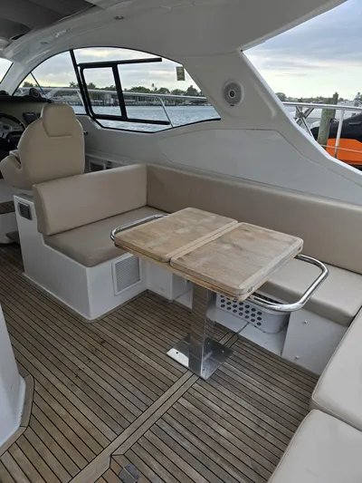 Ghost Yacht Photos Pics 2018 Azimut Atlantis 43 yacht interior with beige seating and wooden table.