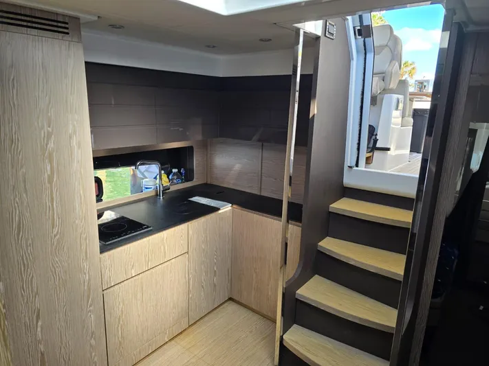 Ghost Yacht Photos Pics Interior of 2018 Azimut Atlantis 43 yacht, featuring modern kitchen and wooden stairs.