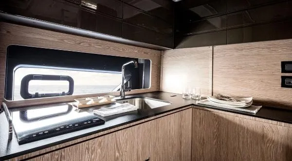 Ghost Yacht Photos Pics Modern kitchen interior of 2018 Azimut Atlantis 43 yacht with sleek design and wood finish.