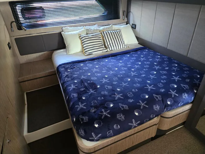 Ghost Yacht Photos Pics Luxurious bedroom in 2018 Azimut Atlantis 43 yacht with nautical-themed bedding.