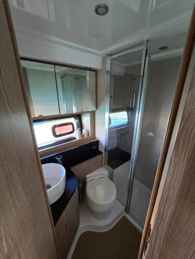 Ghost Yacht Photos Pics Bathroom interior of 2018 Azimut Atlantis 43 yacht with modern fixtures.