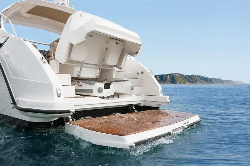 Ghost Yacht Photos Pics Azimut Atlantis 43 yacht, 2018 model, featuring a sleek rear deck on the water.