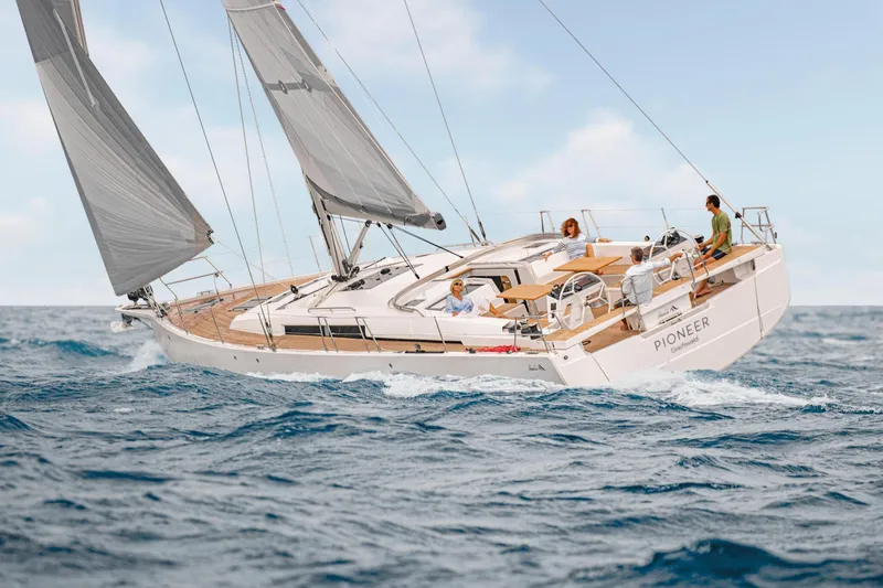  Yacht Photos Pics 2025 Hanse 510 sailboat cruising on open sea with passengers enjoying the ride.