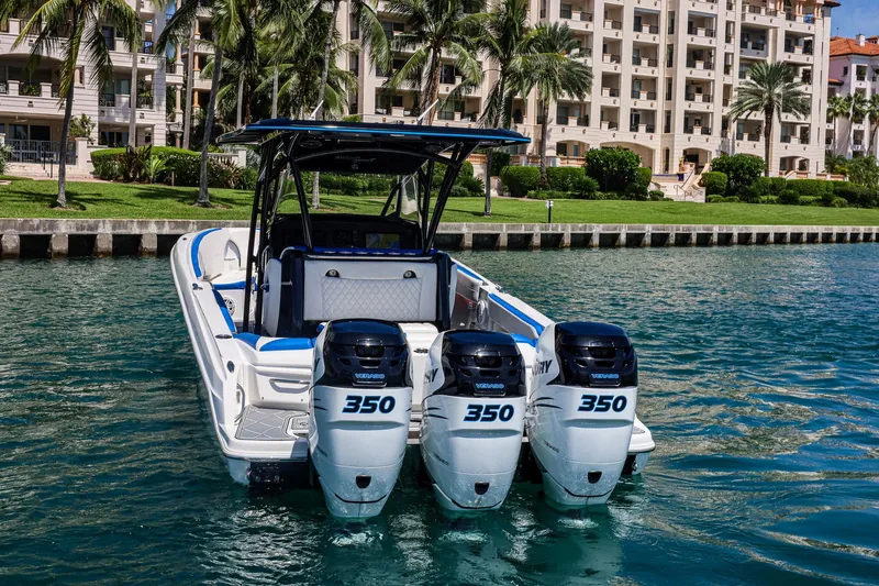 Knotty G Yacht Photos Pics 2020 Nor-Tech 340 boat with triple 350 engines, docked near waterfront buildings.