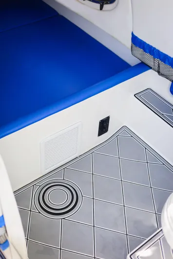 Knotty G Yacht Photos Pics 2020 Nor-Tech 340 interior with blue seating and patterned flooring.