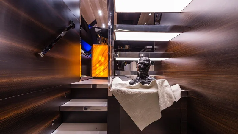  Yacht Photos Pics Luxurious interior of 2014 Admiral Silent 76 yacht with modern staircase and decorative sculpture.