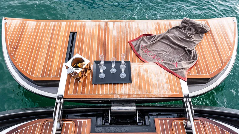 Yacht Photos Pics Luxury yacht deck with wooden finish, featuring glasses and a towel, Admiral Silent 76, 2014.