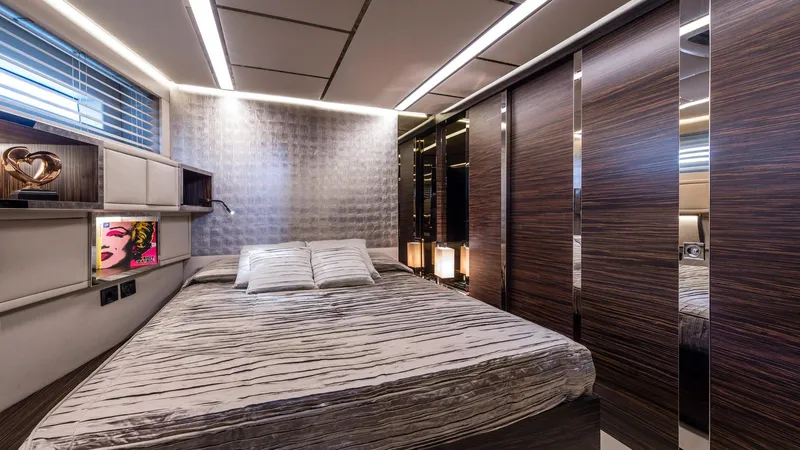  Yacht Photos Pics Luxurious bedroom interior on 2014 Admiral Silent 76 yacht, featuring modern design and ambient lighting.