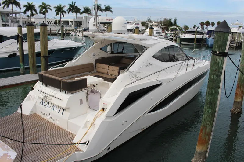  Yacht Photos Pics 2017 Galeon 385 HTS yacht docked at marina with palm trees in background.