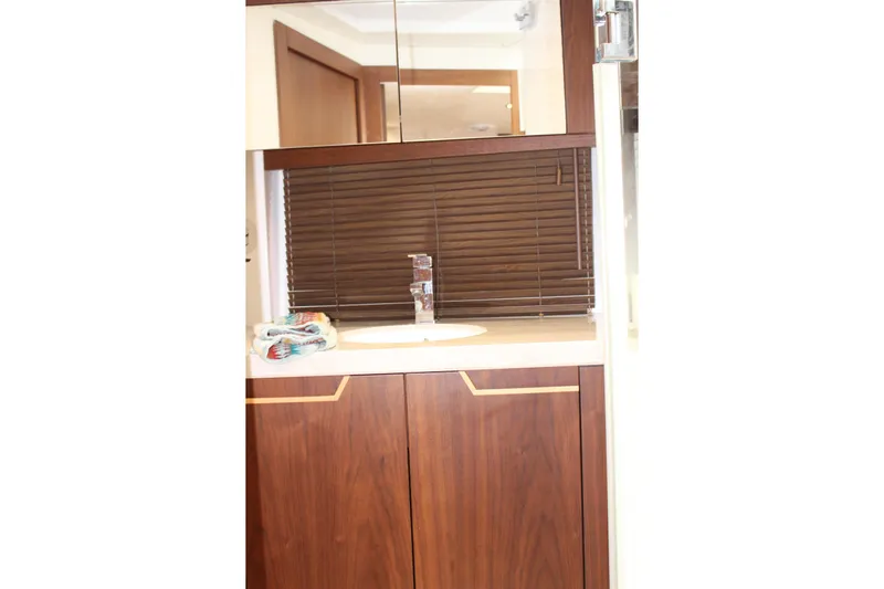  Yacht Photos Pics Luxurious bathroom interior of 2017 Galeon 385 HTS yacht with wooden cabinetry and modern fixtures.