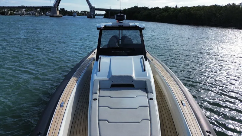  Yacht Photos Pics Technohull 47 Omega 2023 on calm water with bridge in background.