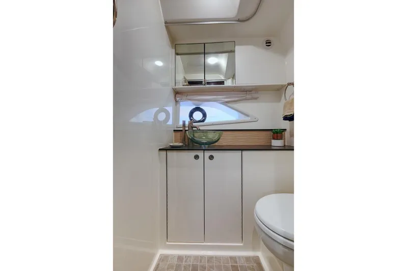  Yacht Photos Pics Modern bathroom in 2025 Sea Ray Sundancer 320 yacht with sleek design and glass sink.