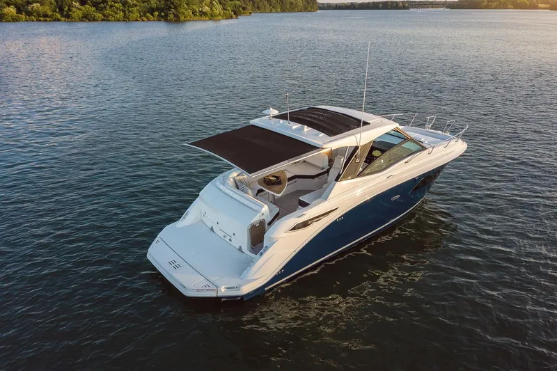  Yacht Photos Pics 2025 Sea Ray Sundancer 320 yacht on calm water, featuring sleek design and spacious deck.