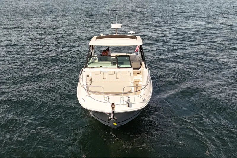  Yacht Photos Pics 2025 Sea Ray Sundancer 320 cruising on open water, front view.