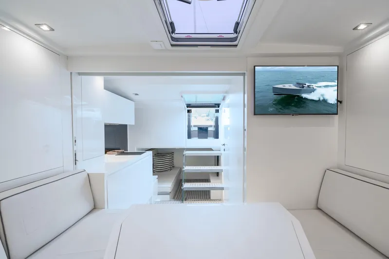 Brix Yacht Photos Pics Interior of 2023 VanDutch 48 yacht, featuring modern design and a mounted TV screen.