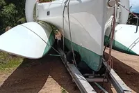 Custom Trimaran Polynésie 42, 2008 model, on trailer under clear blue sky.