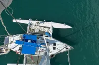 Aerial view of 2008 Custom Trimaran Polynésie 42 sailing on clear water.