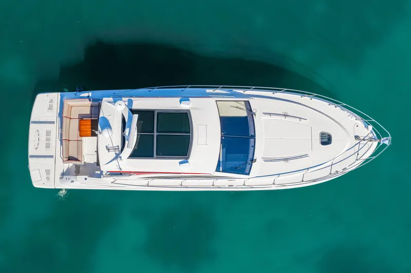  Yacht Photos Pics Aerial view of 2016 Sea Ray 510 Sundancer yacht on clear turquoise water.
