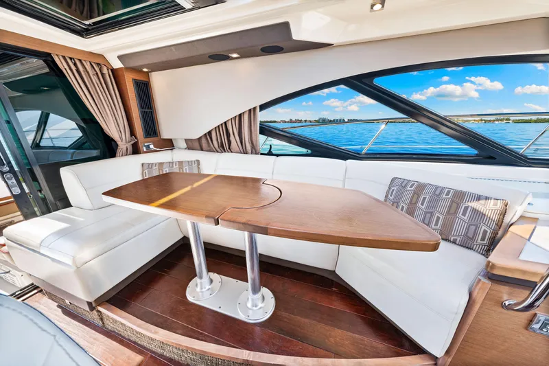  Yacht Photos Pics Luxurious interior of 2016 Sea Ray 510 Sundancer yacht with elegant seating and scenic ocean view.
