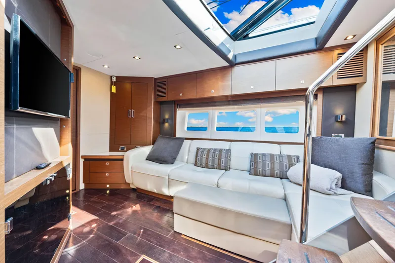  Yacht Photos Pics Luxurious interior of 2016 Sea Ray 510 Sundancer yacht with skylight and modern furnishings.