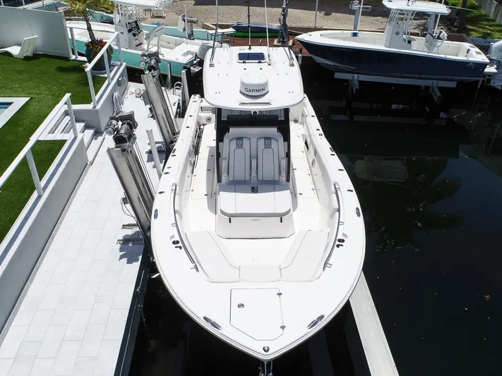  Yacht Photos Pics 2024 Sea Fox 328 Commander boat docked, aerial view, showcasing sleek design and spacious deck.