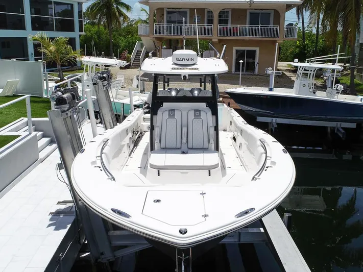  Yacht Photos Pics 2024 Sea Fox 328 Commander boat docked, featuring a sleek design and advanced Garmin navigation system.