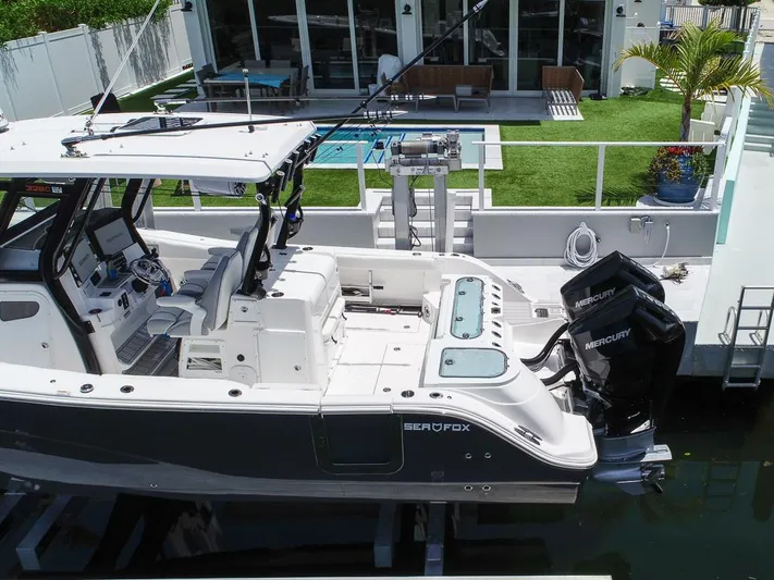  Yacht Photos Pics 2024 Sea Fox 328 Commander boat docked, featuring dual Mercury engines and modern cockpit design.