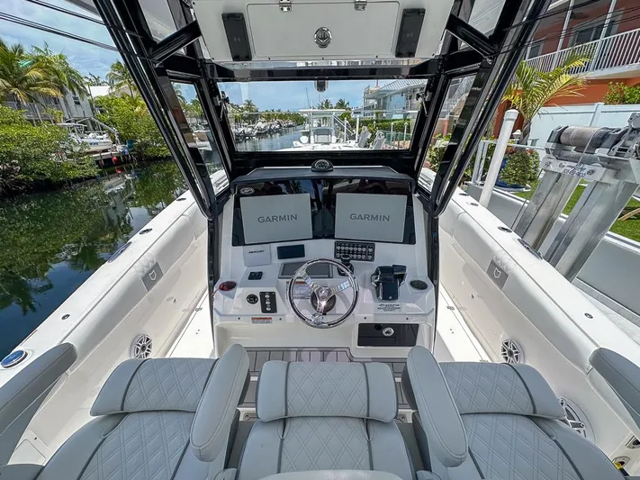  Yacht Photos Pics 2024 Sea Fox 328 Commander boat cockpit with Garmin displays and luxurious seating.
