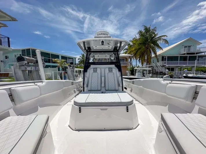 Yacht Photos Pics 2024 Sea Fox 328 Commander boat interior with seating, under a clear blue sky.