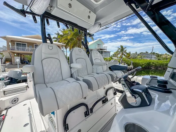  Yacht Photos Pics 2024 Sea Fox 328 Commander boat interior with luxurious seating and modern controls.