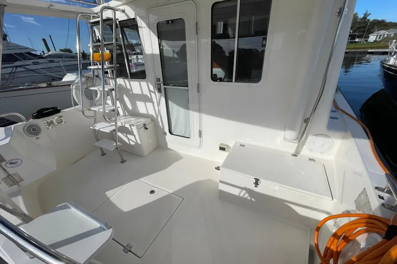  Yacht Photos Pics 2015 Nordic Tug 39 boat deck with ladder, seating, and storage compartments.