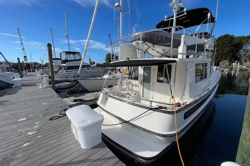  Yacht Photos Pics 2015 Nordic Tug 39 docked at marina under clear blue sky.
