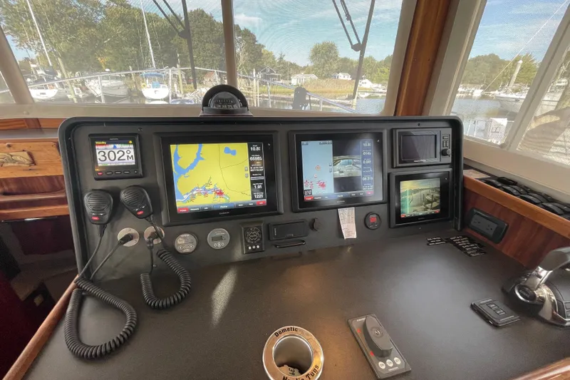  Yacht Photos Pics Nordic Tug 39 (2015) helm with navigation screens and controls, docked at marina.