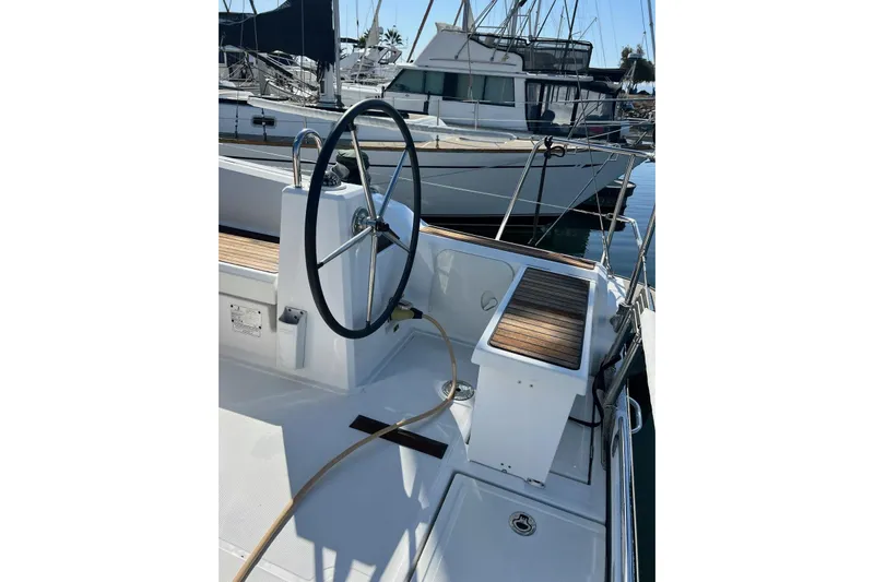 Toofun Yacht Photos Pics Steering wheel of 2016 Beneteau Oceanis 38 sailboat docked at marina.