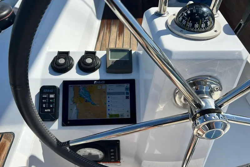 Toofun Yacht Photos Pics Steering console of 2016 Beneteau Oceanis 38 with navigation instruments and compass.