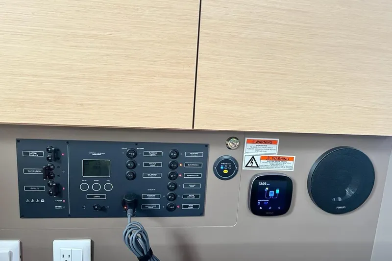 Toofun Yacht Photos Pics Control panel of a 2016 Beneteau Oceanis 38 sailboat with various switches and displays.