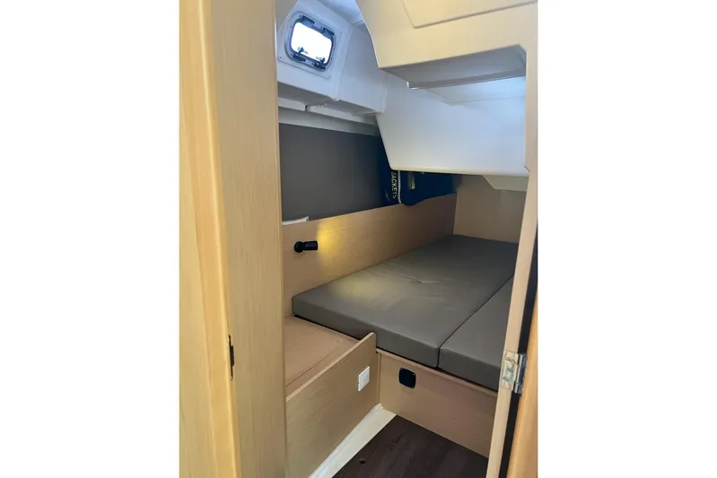 Toofun Yacht Photos Pics Interior cabin of 2016 Beneteau Oceanis 38 sailboat with cozy bed and window.